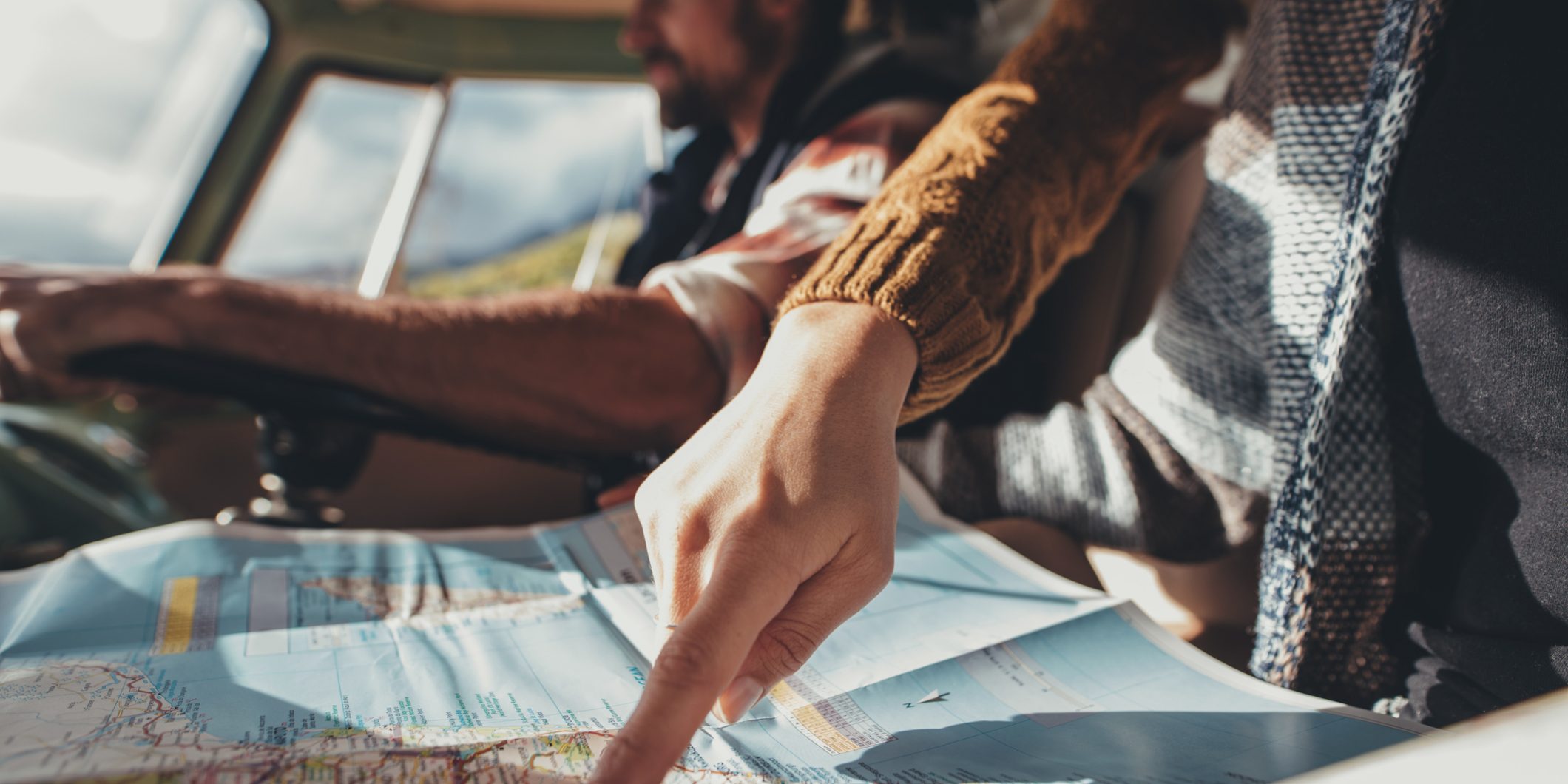 Friends on road trip using map for directions